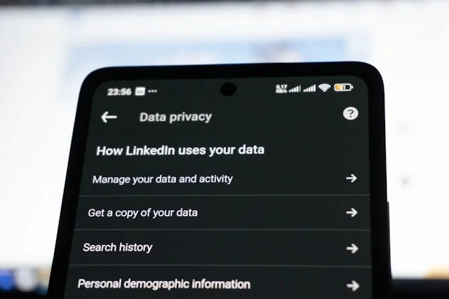 Smartphone screen showing LinkedIn Data Privacy settings menu with options to manage data and activity