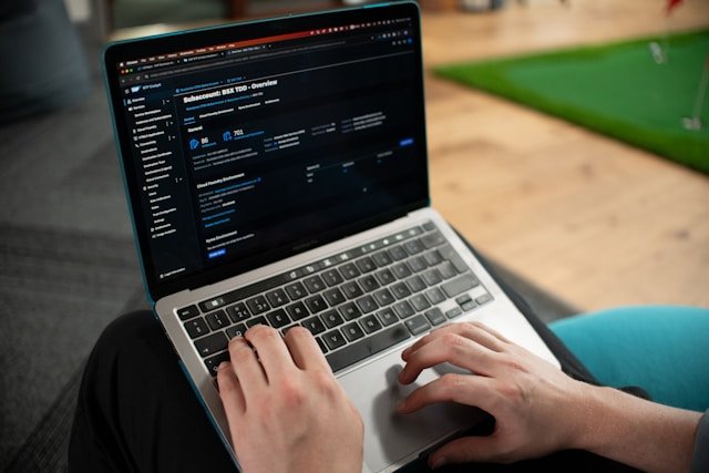 Person using a laptop displaying a cloud account management dashboard with subaccount overview and provisioning settings